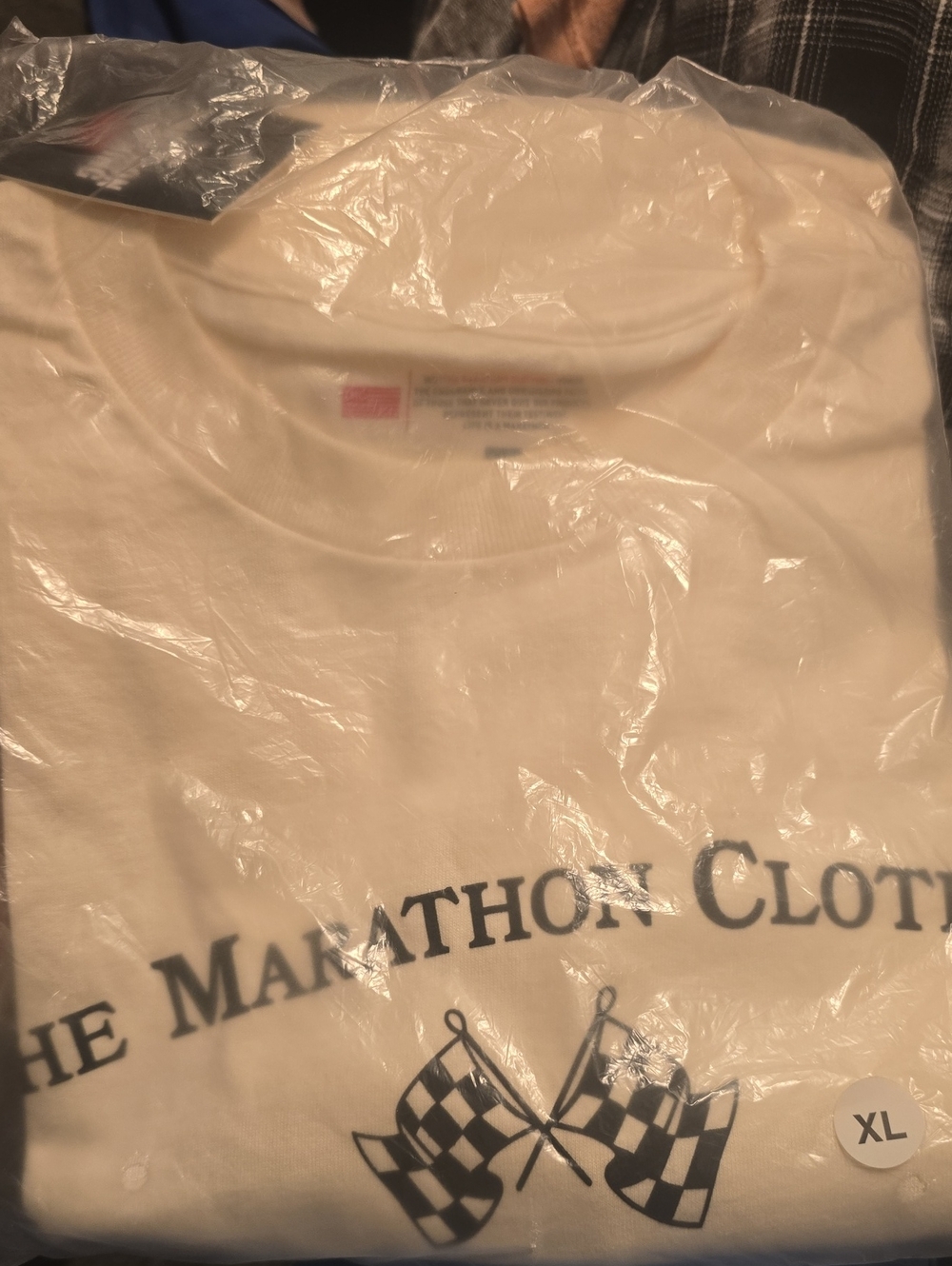 The Marathon Clothing Cream Tee with Navy Checkered Flag Graphic